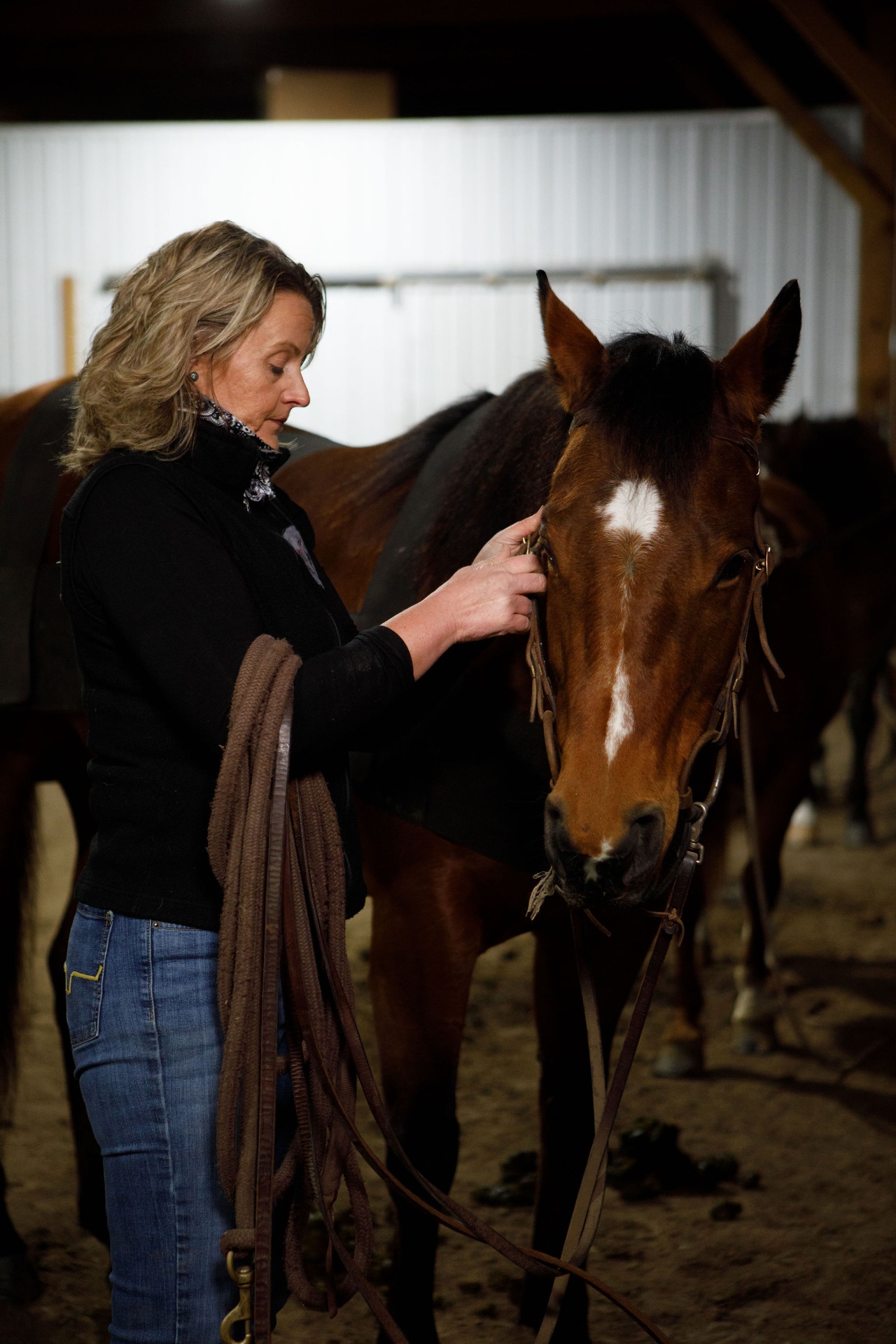 Becky Pearson with her horse in the barn